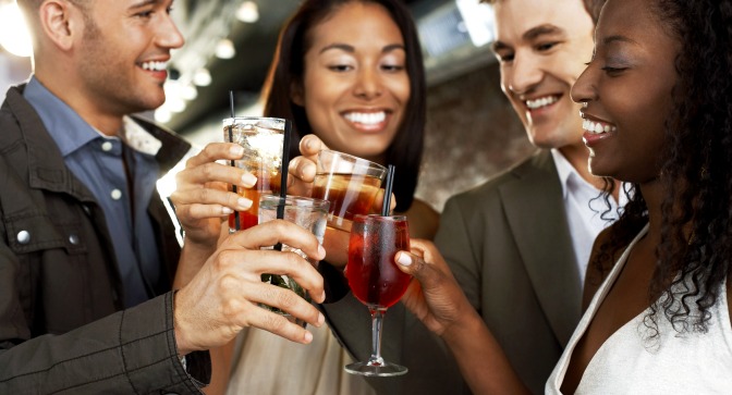 Four friends toasting each other