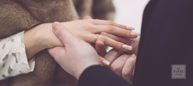 couple outdoors, man putting engagement ring on fiance's finger