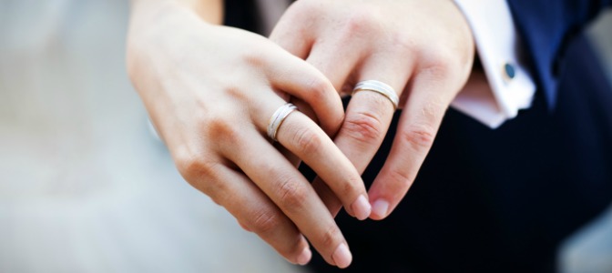 Why are engagement and wedding rings worn on the fourth finger of the left hand?